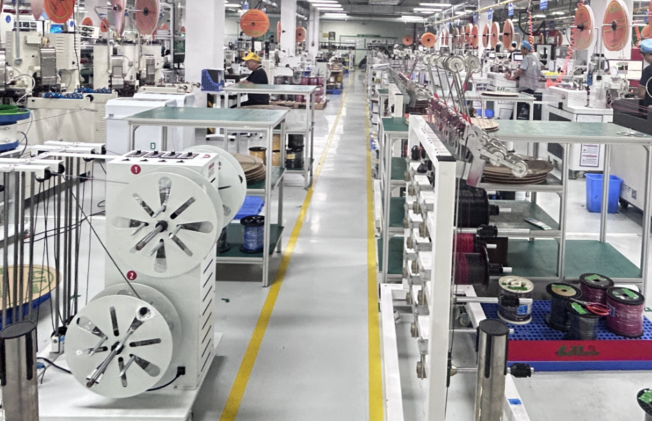 High-speed automated stripping and crimping machinery at WireAssyTech workshop